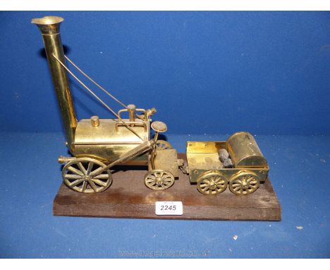 A brass model steam engine and tender on plinth, 13'' x 10 1/2'' x 5 1/2''.