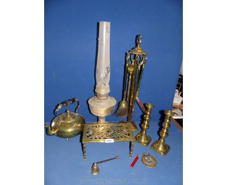 A brass Companion set, teapot, pair of candlesticks and trivet.