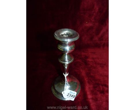 A Birmingham silver Candlestick with weighted base, dated 1925, makers mark rubbed, some dings and slight tilt.