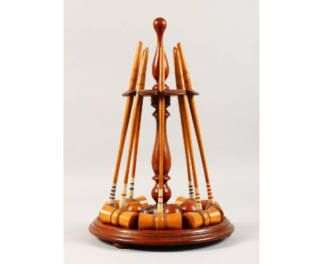 A LATE 19TH CENTURY MAHOGANY AND BOXWOOD TABLE CROQUET SET, comprising a turned mahogany stand, seven boxwood mallets and fiv