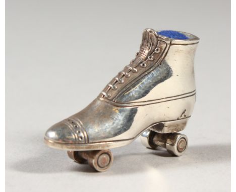 A NOVELTY SILVER ROLLER SKATE PIN CUSHION.