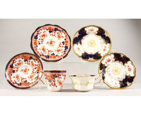 A COALPORT TRIO AND A HAMMERSLEY TRIO, blue and gilt painted with roses.