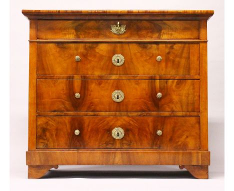 AN 18TH CENTURY CONTINENTAL WALNUT COMMODE, with four long drawers, with brass handles, on bracket feet. 3ft 4ins wide x 2ft 