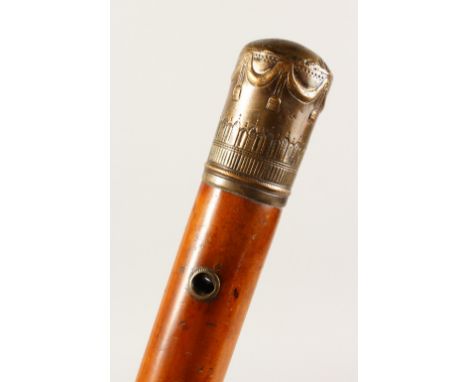 A 19TH CENTURY MALACCA WALKING STICK, with engraved gilt metal pommel and lanyard holes. 31.5ins long.