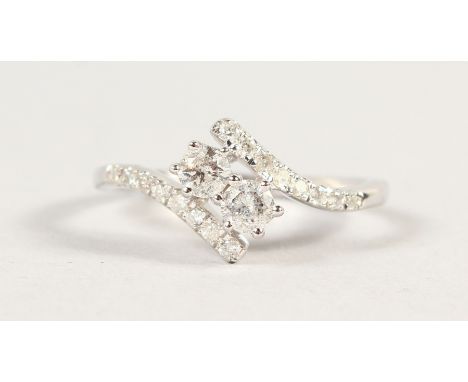 A 9CT GOLD TWO STONE DIAMOND CROSSOVER RING.