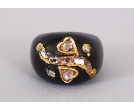A BLACK ONYX AND DIAMOND RING.