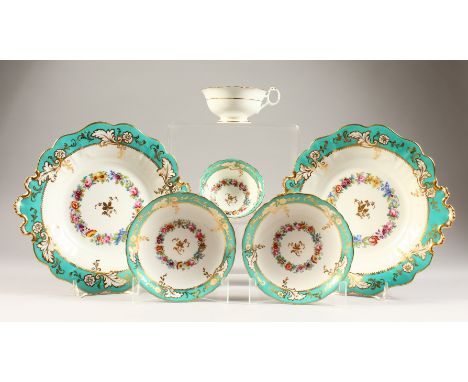 A SET OF TWO CAKE PLATES and two cups and saucers.