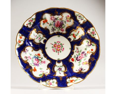 A DR. WALL FIRST PERIOD WORCESTER CIRCULAR PLATE, blue scale border painted with flowers, Chinese blue square mark. 9.5ins di