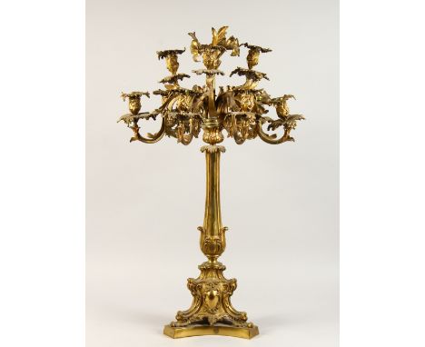 A GOOD 19TH CENTURY ORMOLU NINE LIGHT CANDELABRA of naturalistic form, with scrolling branches, on a triangular shaped base. 