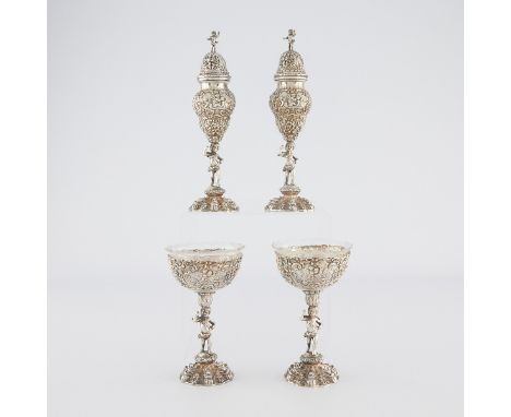 Group of four German 800 silver condiments serving chalices and urns. With putti stems and profuse repousse decoration throug