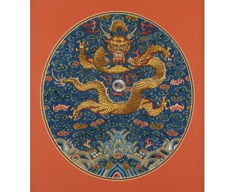 Chinese silk embroidered robe fragment on blue silk depicting a five-clawed golden dragon chasing a flaming pearl. The dragon