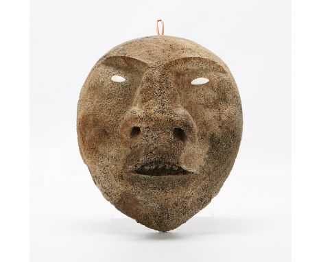 Large Native American Inuit bone mask. Dark and carved with a heavy brown and inset with whiter bone eyes.Height: 6 1/2 in x 
