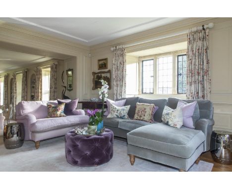 Modern L shaped sofa, SOFA.COM, upholstered in a grey velvet fabric, being sold with two grey cushions, and 3 purple cushions