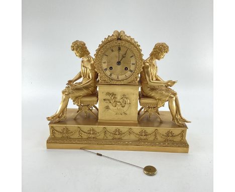 Gilded French mantle clock, flanked by figures of Grecian women sat on Regency style cross stretcher stools,  37cm W x  30cmH