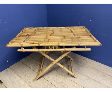 A modern bamboo style conservatory table with folding legs to  X framed base, and a modern circular table with glass top, and