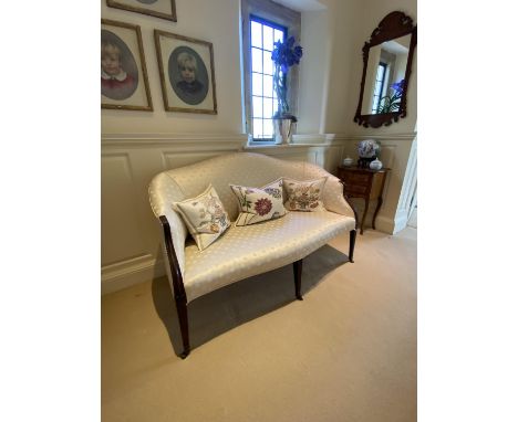 A good show framed settee, upholstered in cream silk fabric, raised on tapered legs to brass drum castors, 144cmL (PLEASE NOT