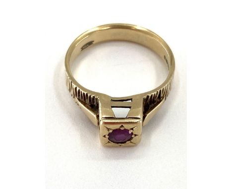 A 9ct gold and ruby ring single round free cut ruby in a raised box bezel mount, 3.65g 