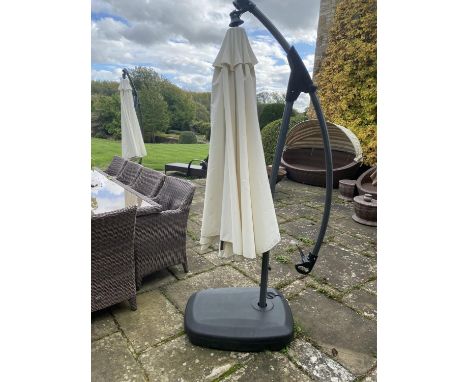 GARDEN FURNITURE: a very large garden parasol, on black all weather base/stand, with water hole to weight item. Parasols in w