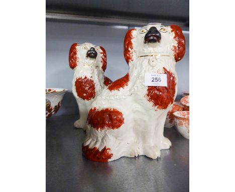 A PAIR OF NINETEENTH CENTURY STAFFORDSHIRE POTTERY MANTEL DOGS 