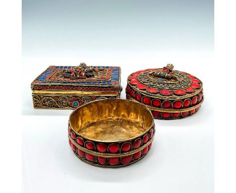 Beautiful round and rectangular shaped jewelry boxes with enamel and beading, designed in a relief of buddha figures. Largest