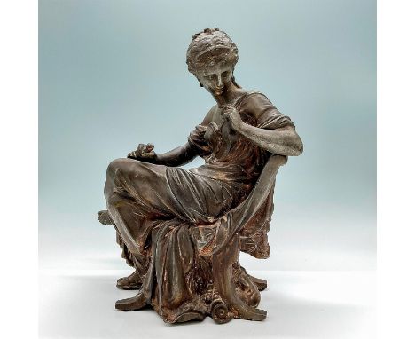 A mixed media sculpture depicted as a seated Greek woman holding her dagger, with the head of a man underneath the chair. Dim