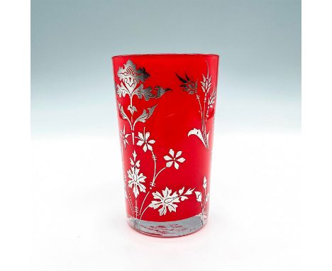 Bright ruby red drinking glass surface decorated with applied silver overlay in patterns using cutting and engraving techniqu
