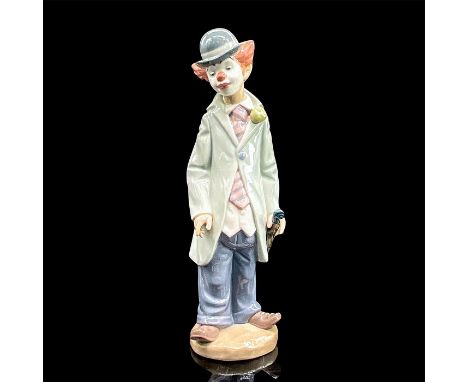 Glazed porcelain figure of a young clown looking downwards holding his violin. Lladro backstamp. Artist: Francisco CatalaIssu