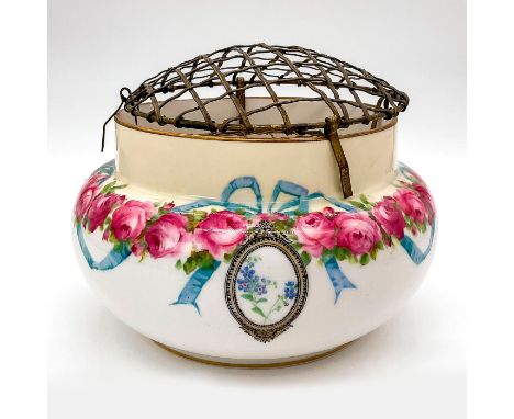 Round porcelain flower bowl decorated with pink roses and blue ribbons; gold gilt border. Removable metal frog. Royal Doulton