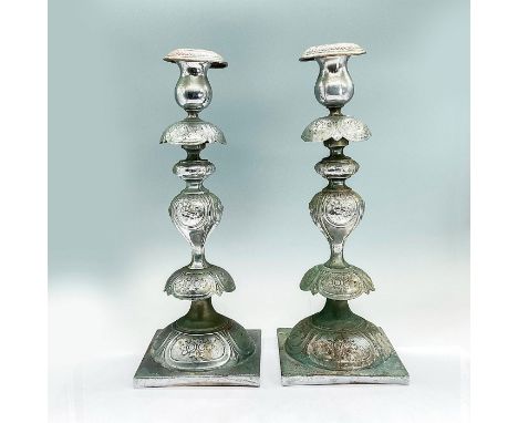Two silver colored metal alloy candlesticks with foliage embossed design. Dimensions: 5.25"L x 5.25"W x 14"Hbr&gt;Condition: 