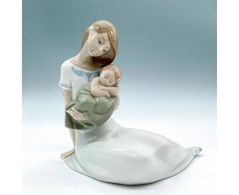 Glossy finish porcelain figure modeled as mother cradling her young while he sleeps peacefully in her arms. Nao by Lladro bac