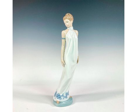 A glazed figure of a woman in a long white dress with a blue floral trim. Nao backstamp. This item has its original box: 15.5