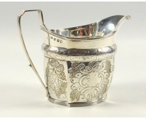 George III oval fluted milk jug with engraved floral decoration, 2 vacant cartouches and bracket handle, London 1801, H 10.6c