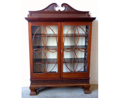 An Edwardian mahogany satinwood and box wood line inlaid bookcase, the top with pierced swan neck and blind fret pediment ove