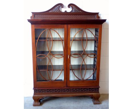 An Edwardian mahogany satinwood and box wood line inlaid bookcase, the top with pierced swan neck and blind fret pediment ove