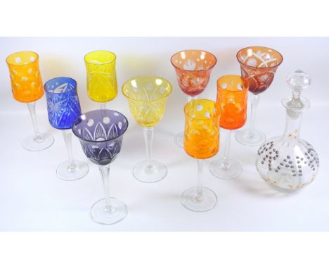Set of four Bohemian coloured hock style drinking glass, a similar set of five coloured drinking glasses with engraved and di
