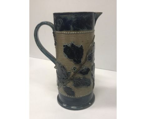 A Victorian glazed stoneware jug with holly decoration, unmarked but in the style of Martin Brothers 26 cm high together with