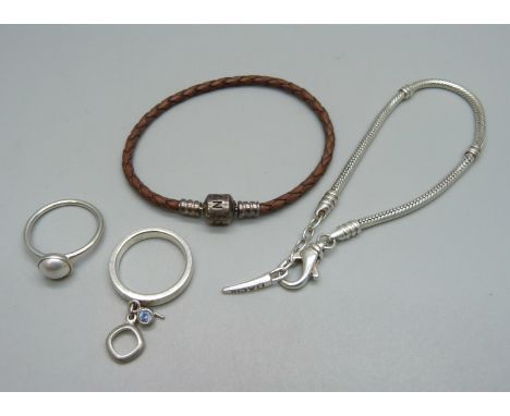 A Pandora charm bracelet, a silver Pandora ring, a silver Fossil ring and a silver Bacio bracelet 