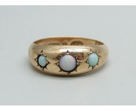 A 9ct gold ring set with three opals, 1.4g, M, some dents to shank 