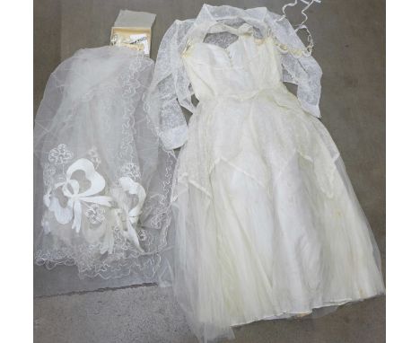 A wedding dress from Thames Board Mills, Purfleet, in original box and packaging with veil, shawl, etc. 