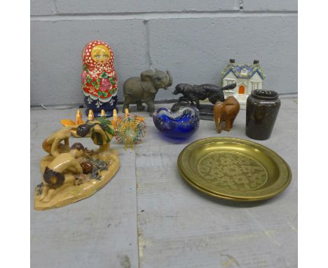 A pewter model of a gun dog, a pair of Indian brass trays, wooden and resin models of elephants, art pottery figure of three 
