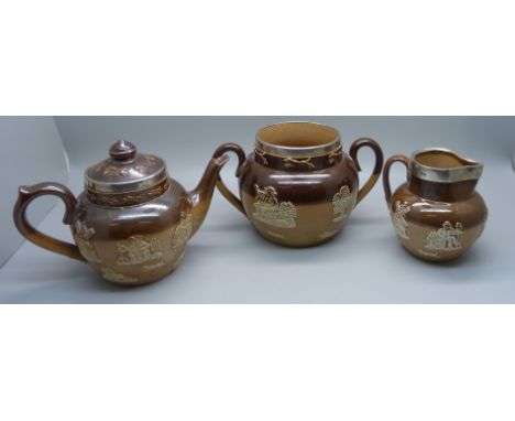 A silver rimmed salt glaze tea service; teapot, sugar and cream 