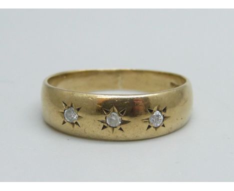 A 9ct gold ring set with three diamonds, 2.7g, R 