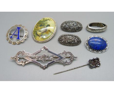 Six silver brooches, a scarf clip and a stick pin, (all test as silver) 