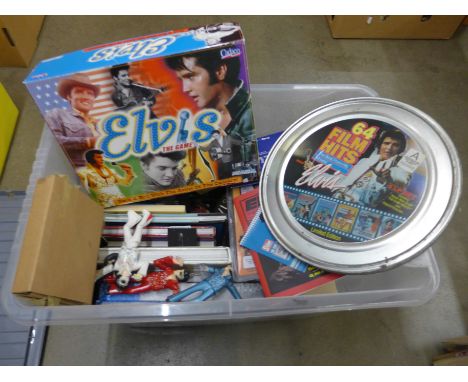 A box of Elvis Presley memorabilia, books, encyclopedia, watches in gift presentation packs, an Elvis board game, a bust of E