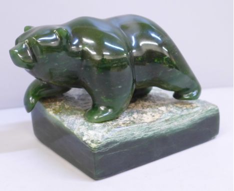 A jade model of a bear, on stand 