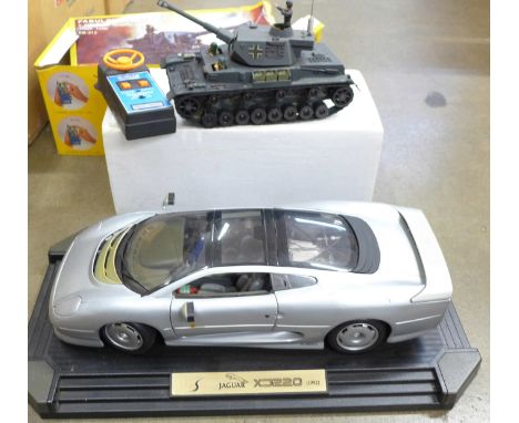 A radio controlled battery operated Tiger Tank, EM-315, boxed and a Maisto Jaguar XD220, boxed 