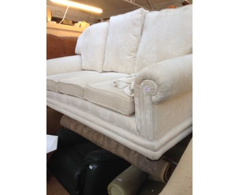 A CREAM FLORAL PATTERNED 3 SEATER SOFA