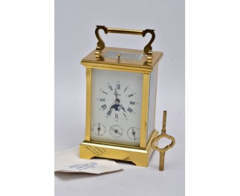 A REPRODUCTION CALENDAR CARRIAGE CLOCK with moon phase, the striking and repeating movement with lever platform, white enamel