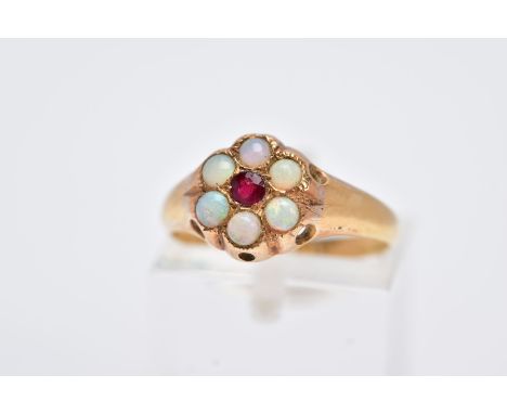 A YELLOW METAL OPAL AND GARNET CLUSTER RING, designed with a central circular cut garnet, within a surround of opal cabochons