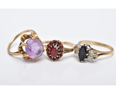 THREE 9CT GOLD GEM SET RINGS, to include an oval cut amethyst set with an openwork scallop edge surround, hallmarked 9ct gold